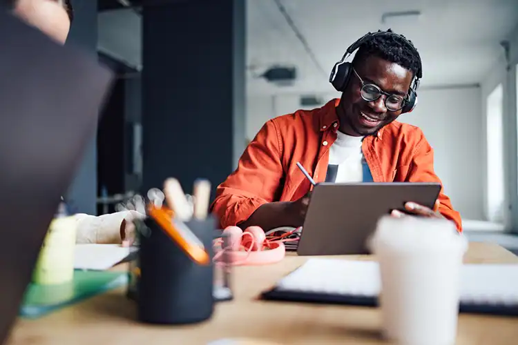 a male online college student working at his desk