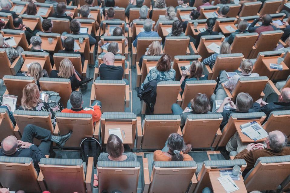 a large group of educational researchers sitting together in a conference hall