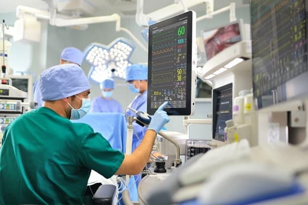 Doctor in surgery room checking status of patient