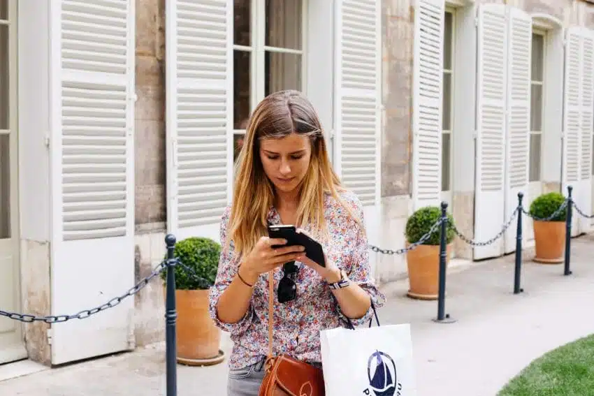 Teenage girl experiencing cyberbullying on her phone