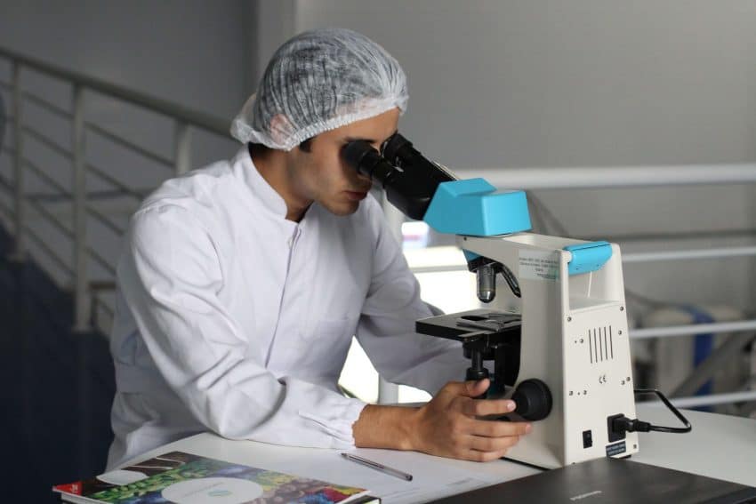 Epidemiologist studying epidemiology with microscope