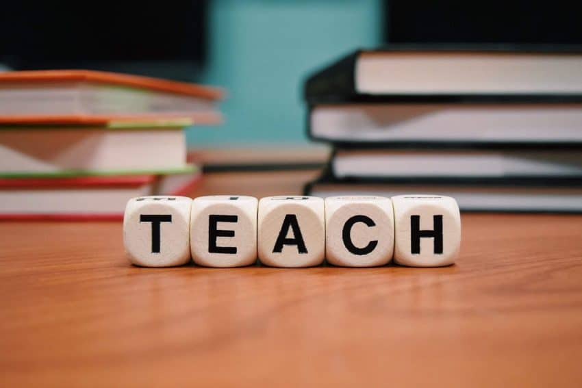 Teach spelled out on a desk with books