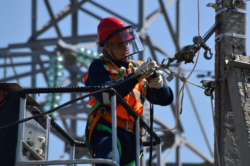 A structural iron and steel worker installs beams for the structure of a building