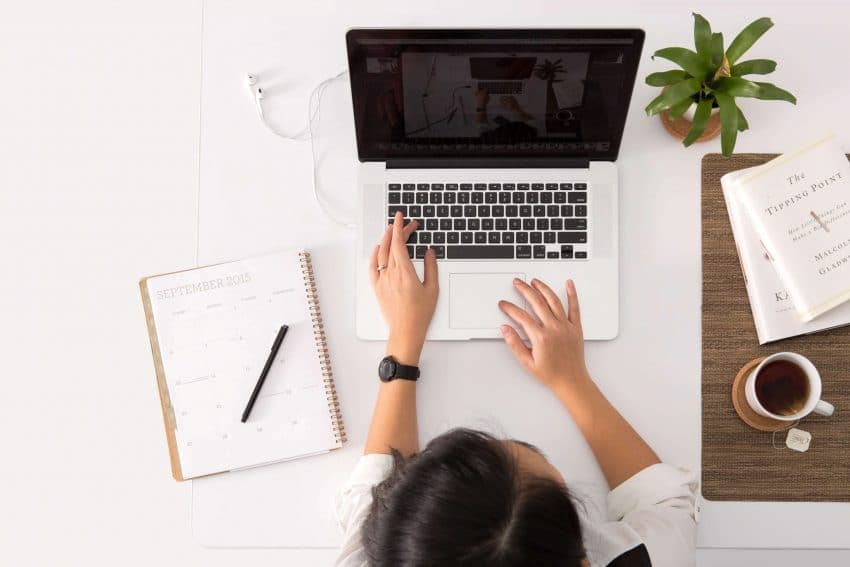 Woman learning online with a laptop and coffee