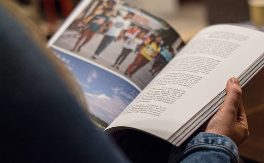 “University of the People student skimming a magazine”