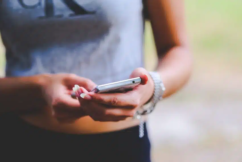 University of the People student holding phone