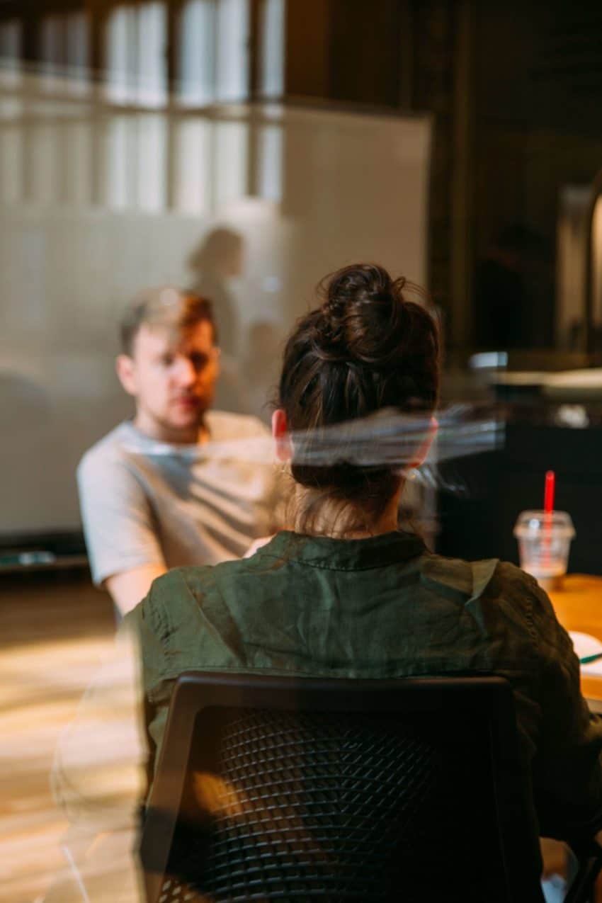 Man and woman talking in a conference room