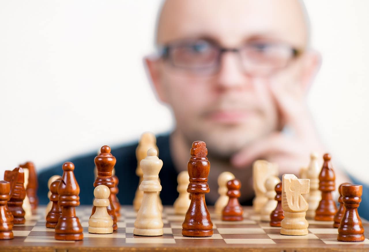 Man thinking behind chessboard
