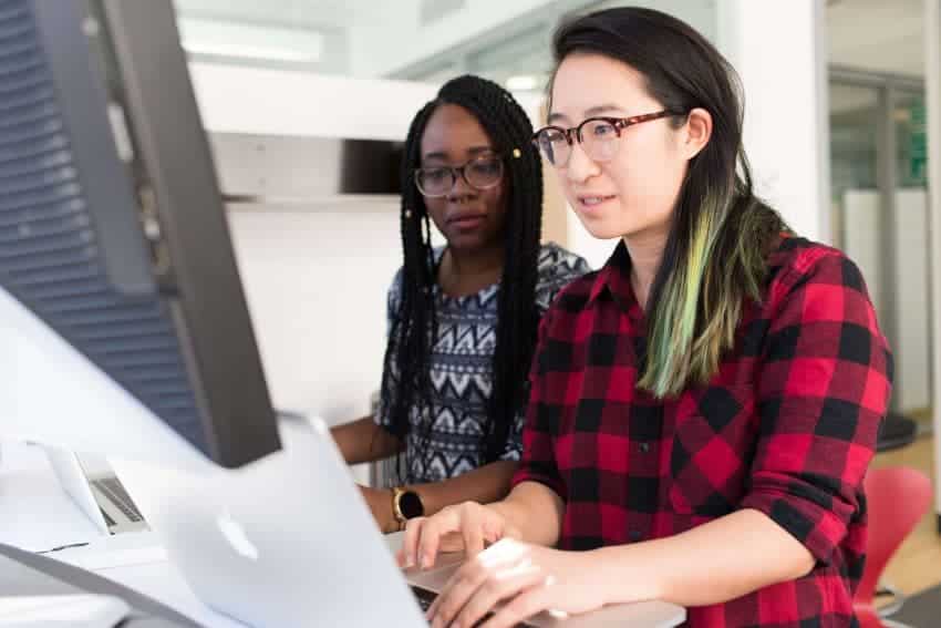 Epic certified women on laptops in healthcare