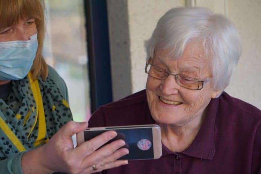 Caregiver with an elderly woman and cellphone