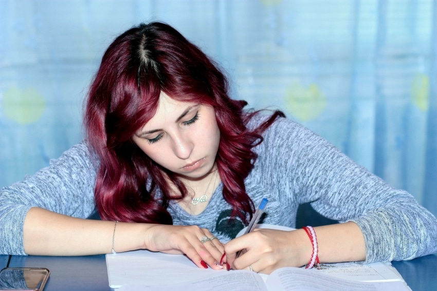 A female University of the People student studying for a test.