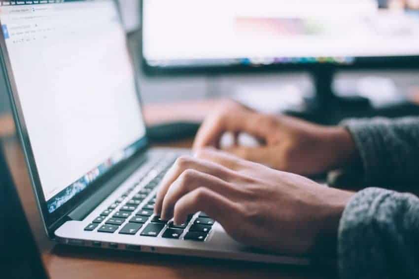 Person typing on a laptop for school