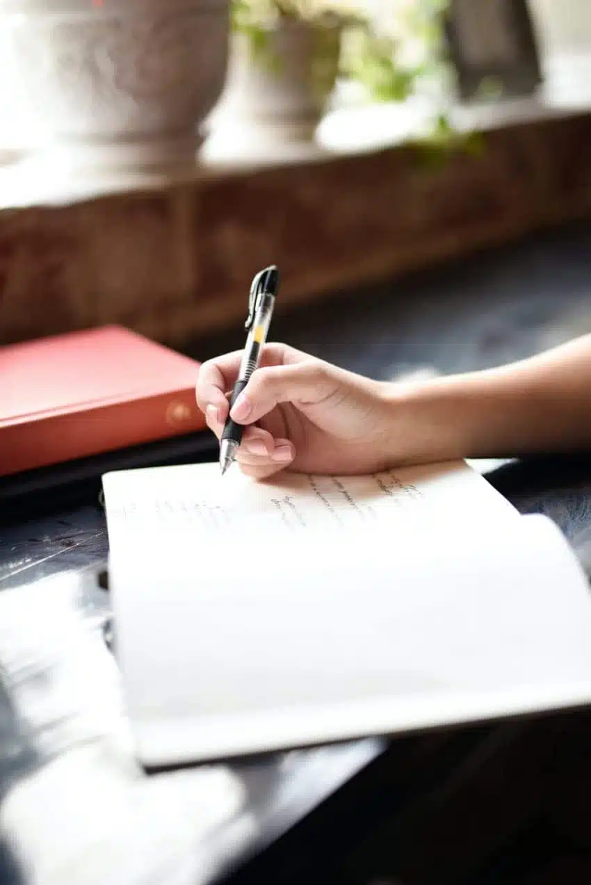 Person writing on a notepad