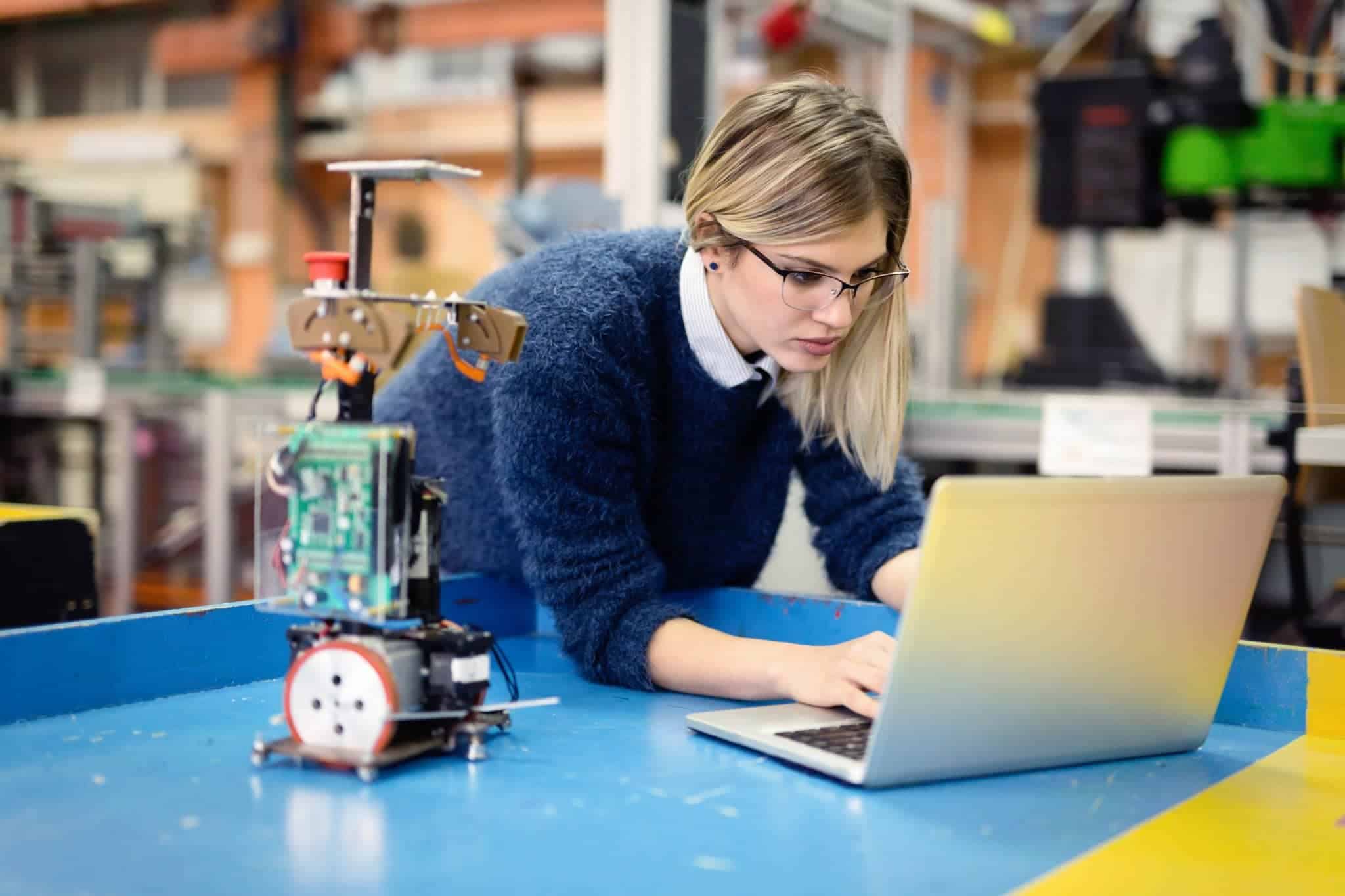 mechanical engineer testing on robotics project on laptop