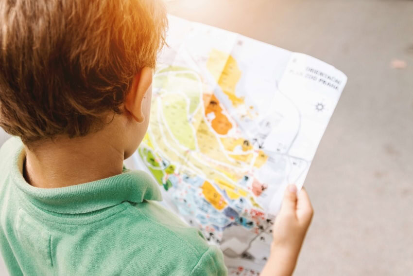 Homeschooled boy using a map to study