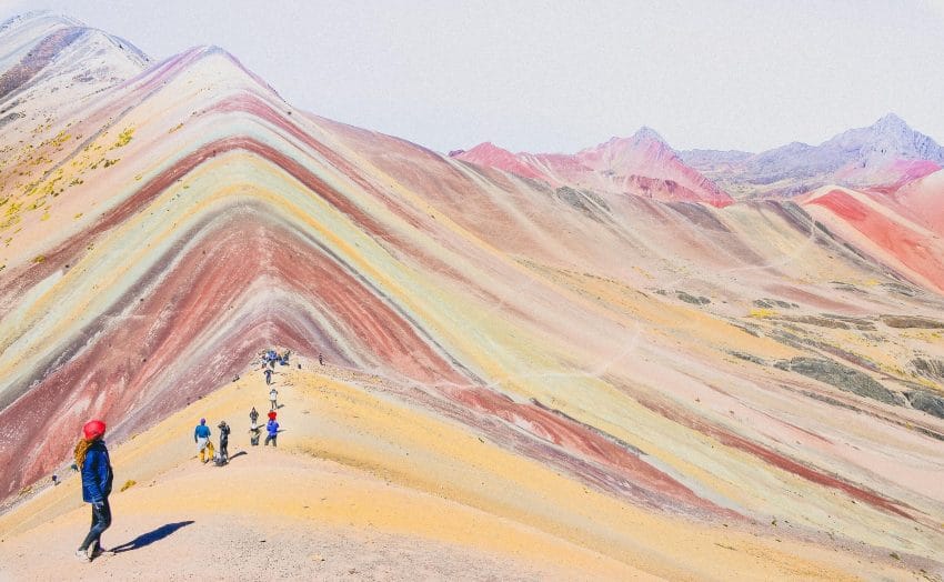 People walking on colored mountain
