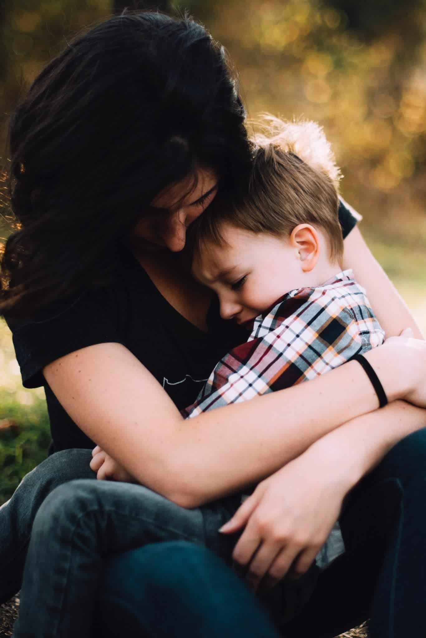 A mom comforts her upset child, as parents just want to protect their kids. 