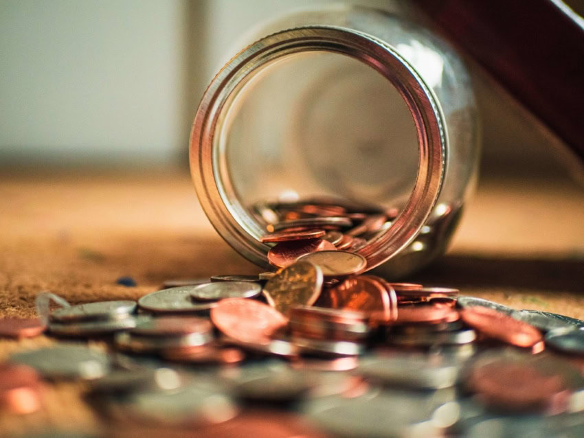 Jar spilled over with coins