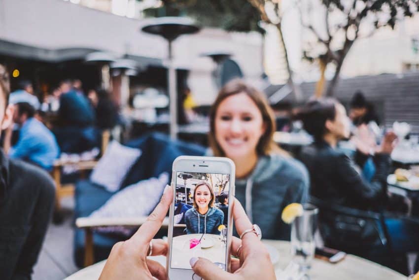 A teacher taking a photo for social media