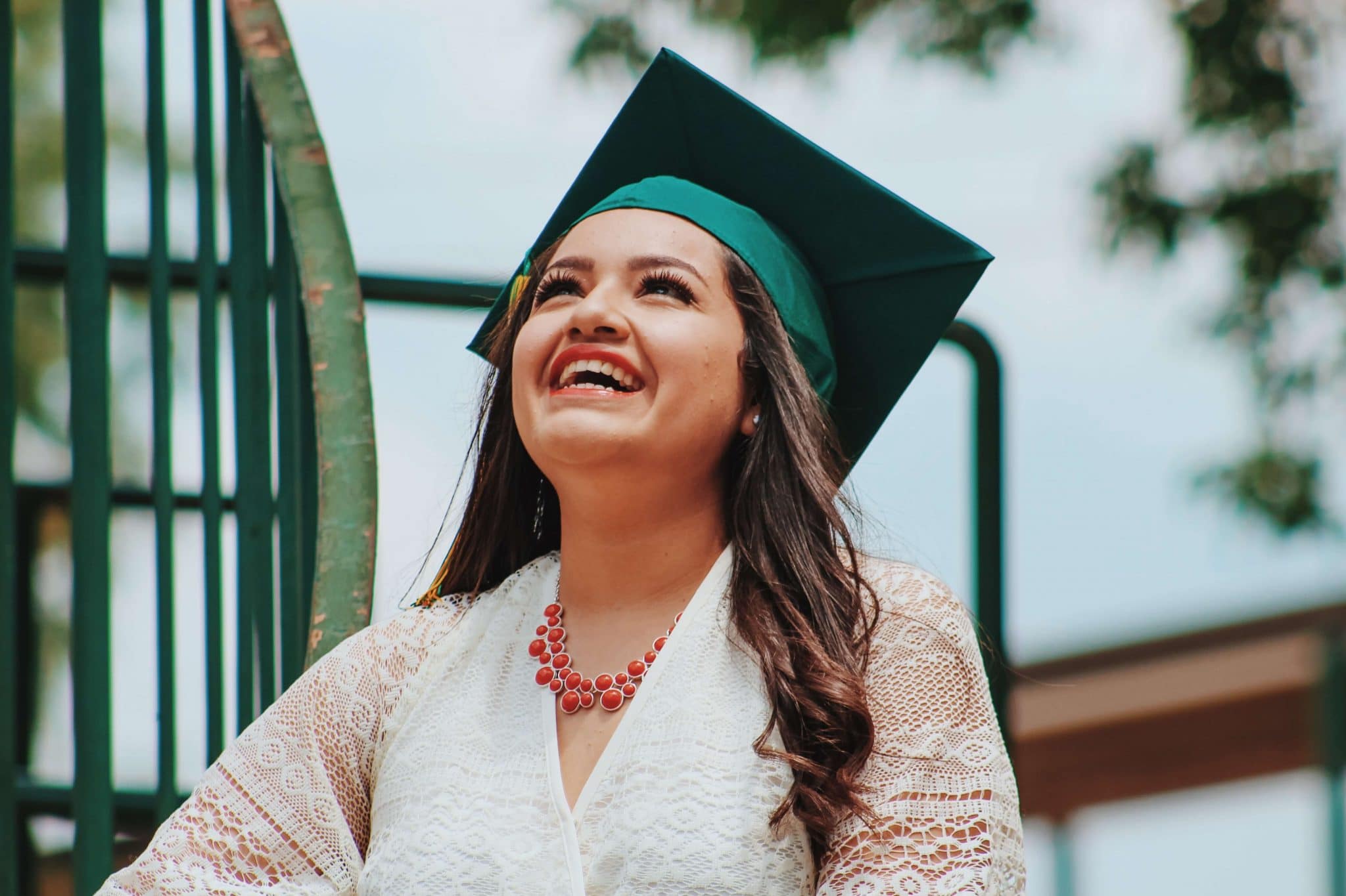 Female graduate smiling and looking up