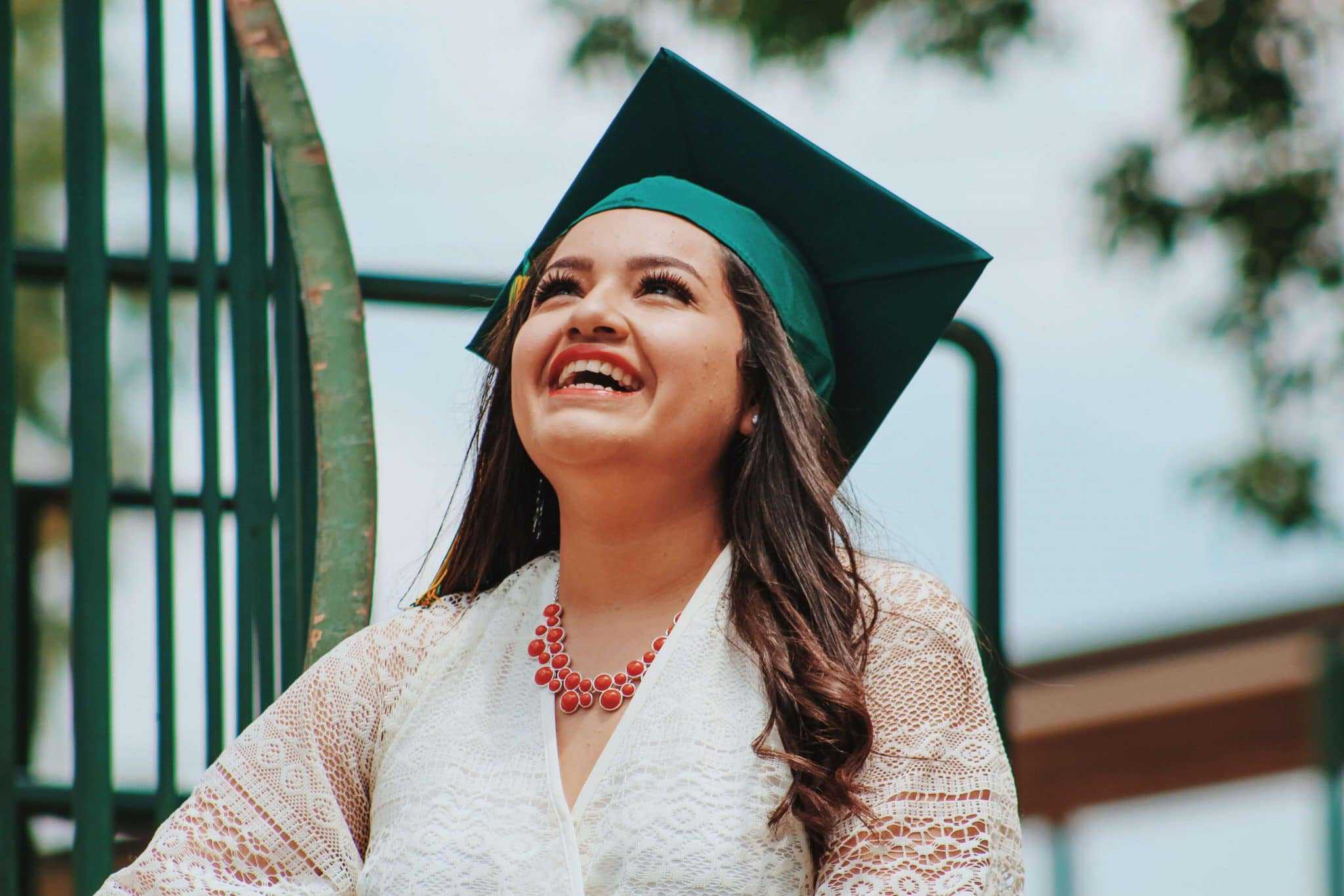 Female graduate smiling and looking up