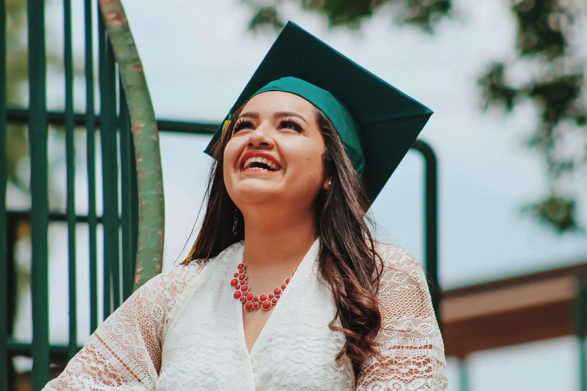Female graduate smiling and looking up