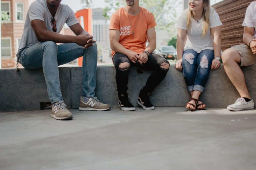 Group of people sitting using non-verbal communication and gestures