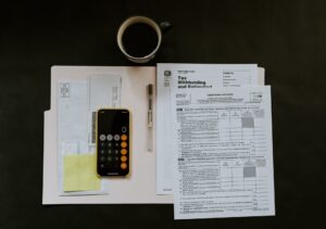 Phone and financial forms on a table    