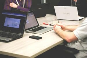 Data scientists working at a table with laptops.