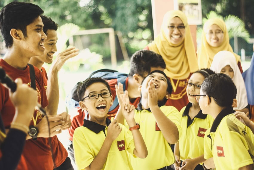 School children socializing and laughing together in between classes.