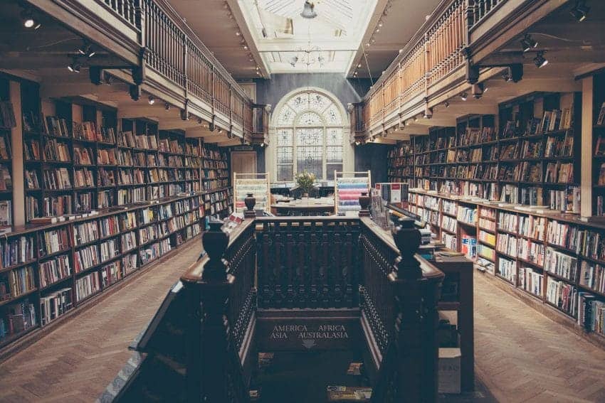 College library with staircase in the middle of the room.