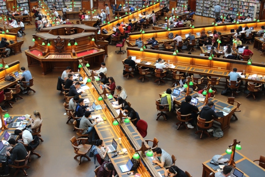 Many students studying at a college library