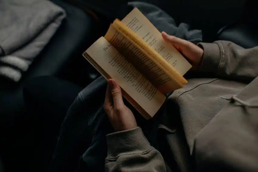 Person reading and practicing literacy