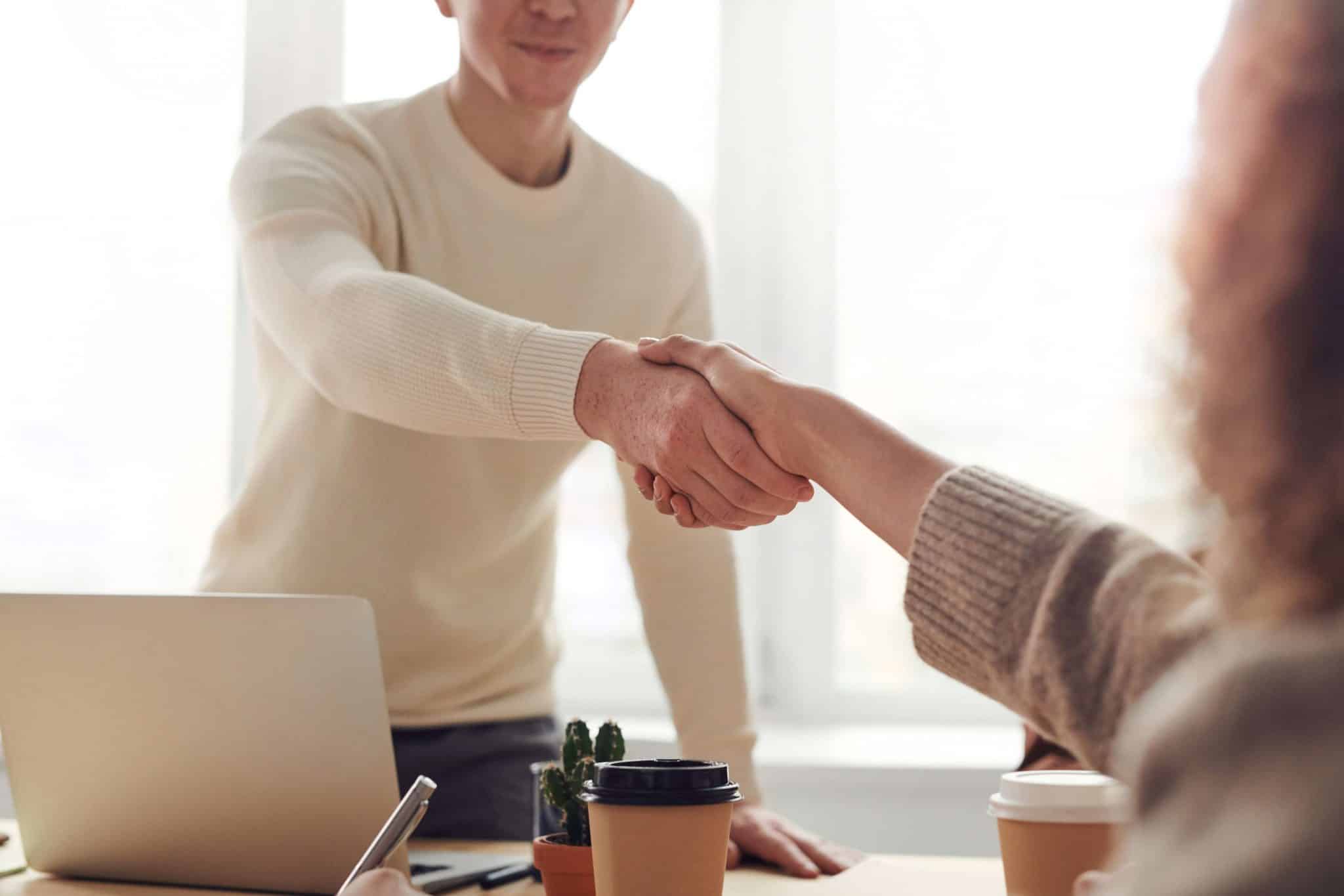 Man and woman shake hands after contract negotiation