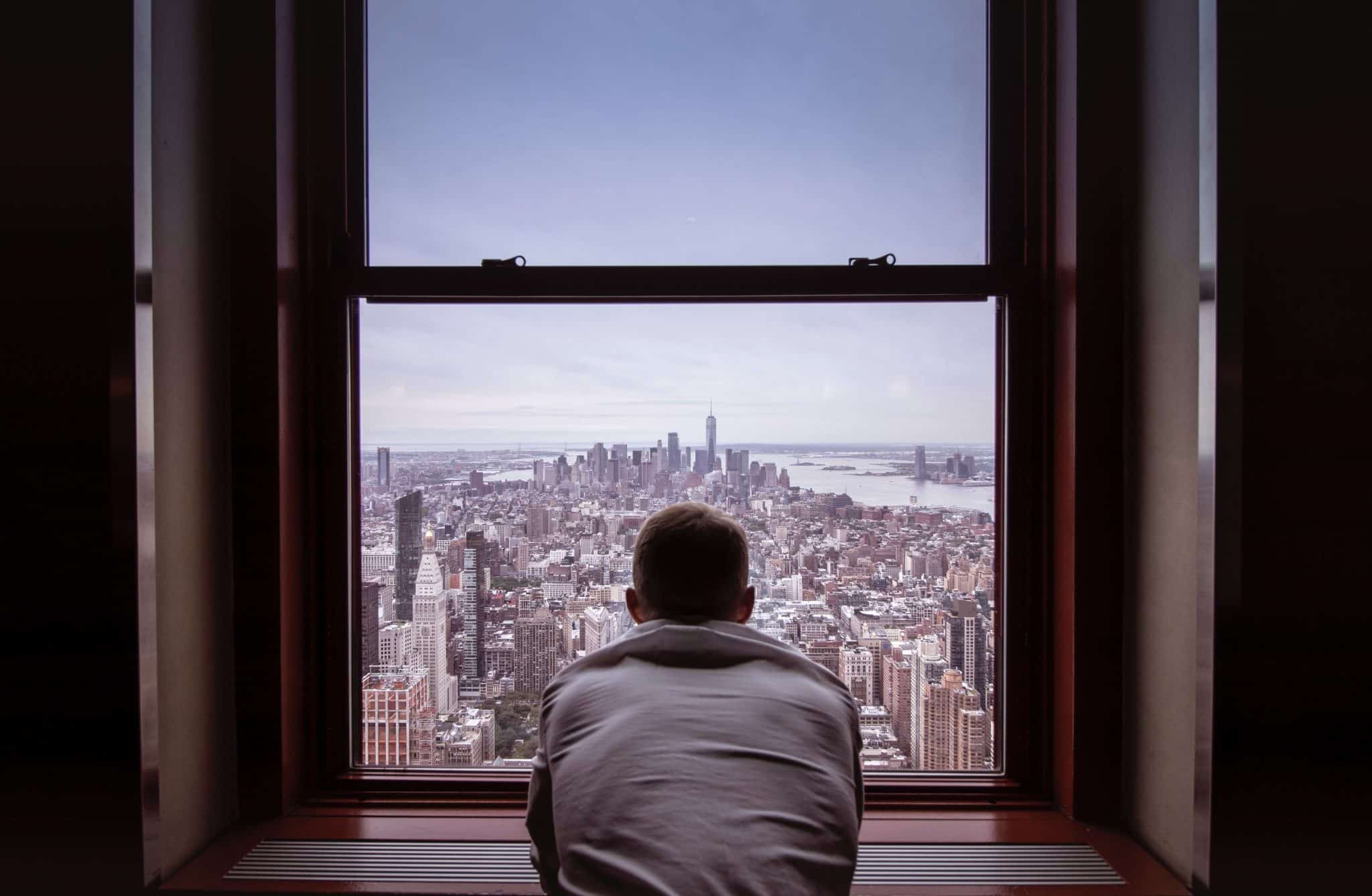 University of the People student reflecting from NYC window