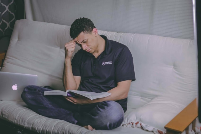 A male University of the People student studying for a test.