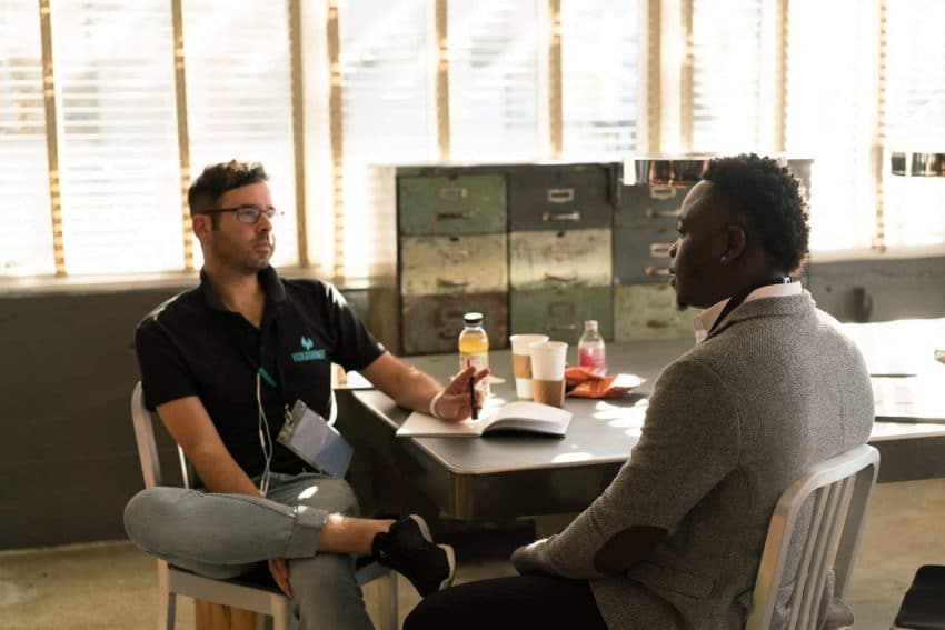 Two men practicing intercultural communication skills at a desk