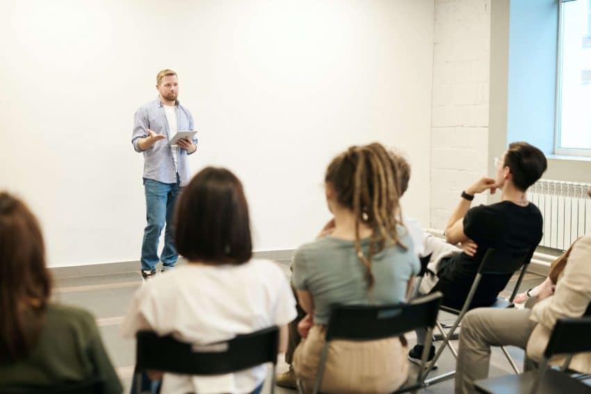 Teacher in front of students in service learning