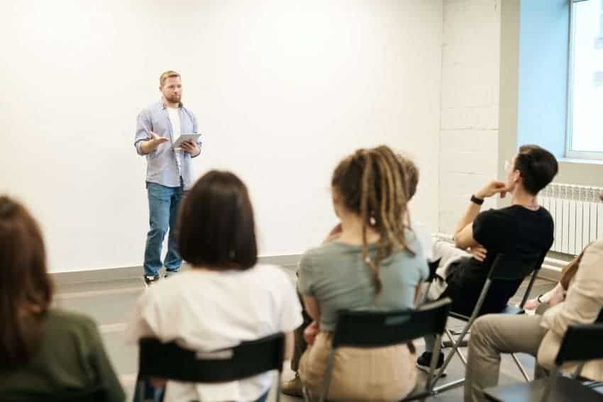 University instructor standing in class with seated students