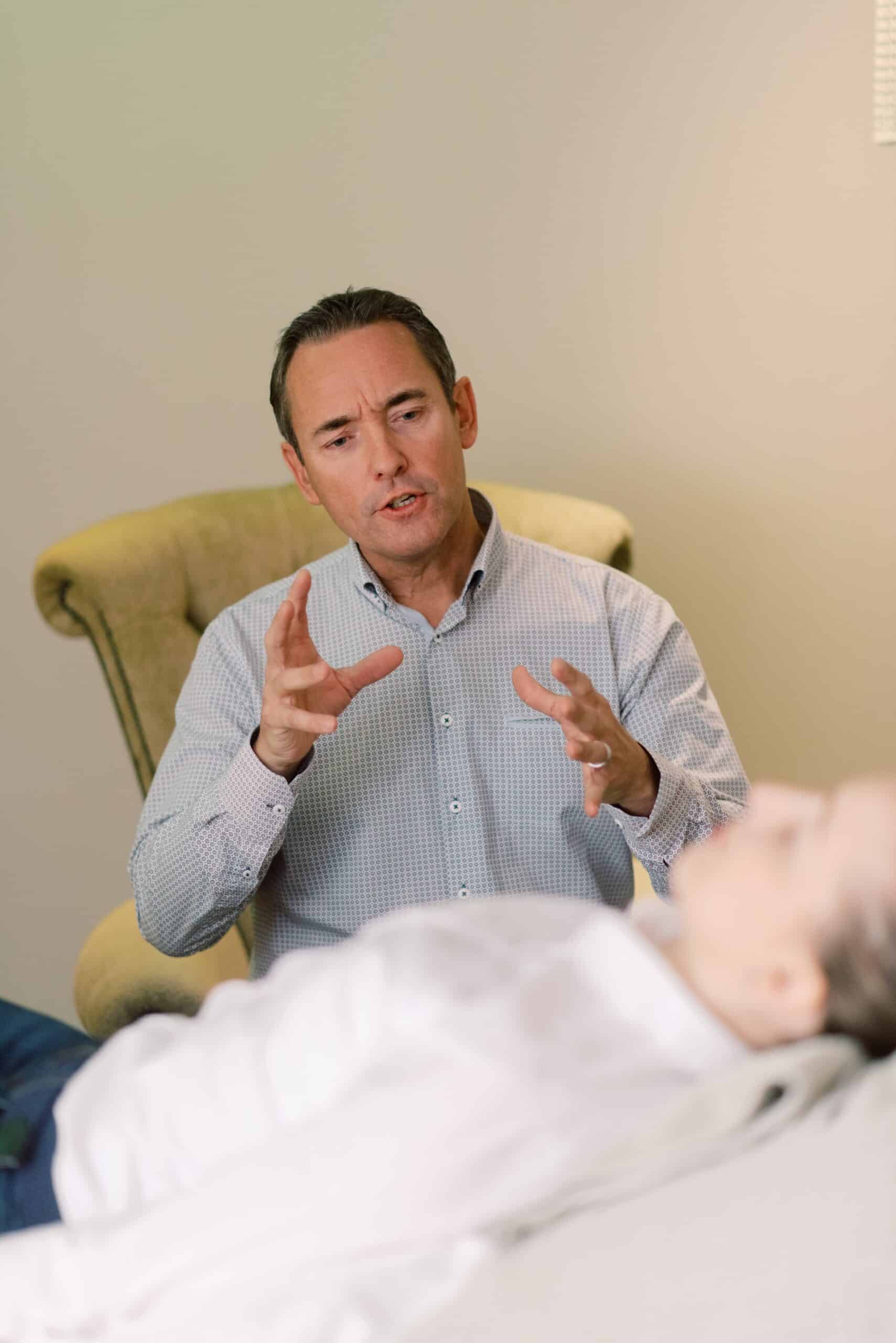 Therapist treating a patient lying on a table