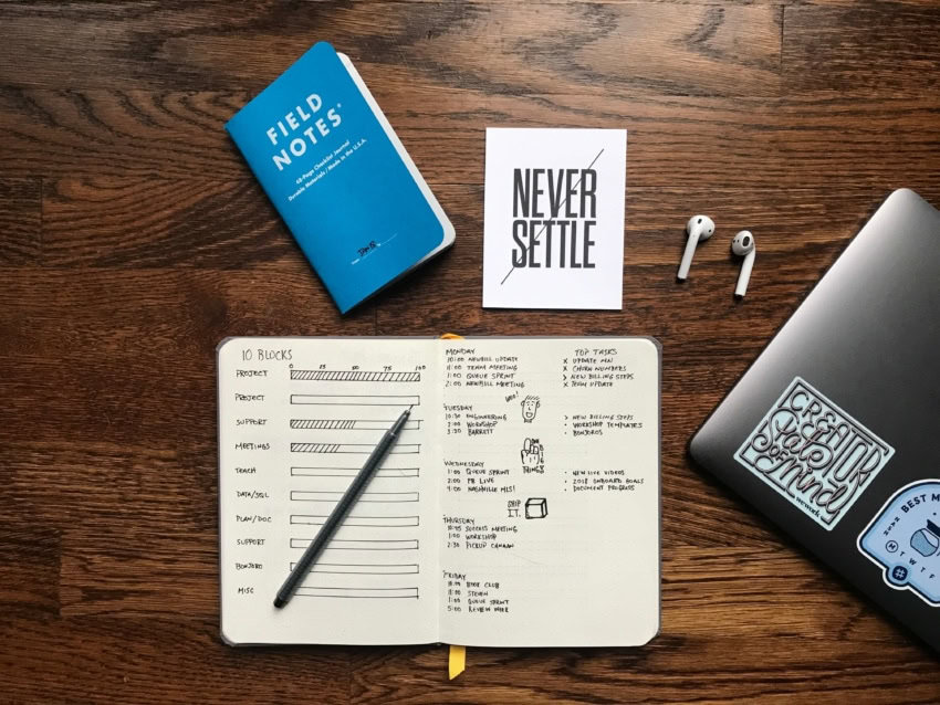 Desk with notebook, laptop, and study supplies