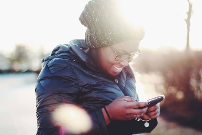 Young woman smiling at phone