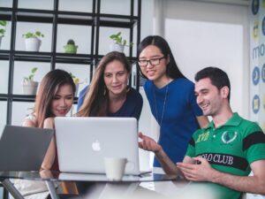 students studying together around a laptop