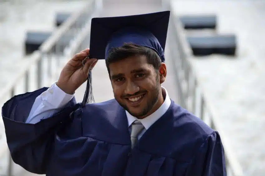 University of the People male student with cap and gown