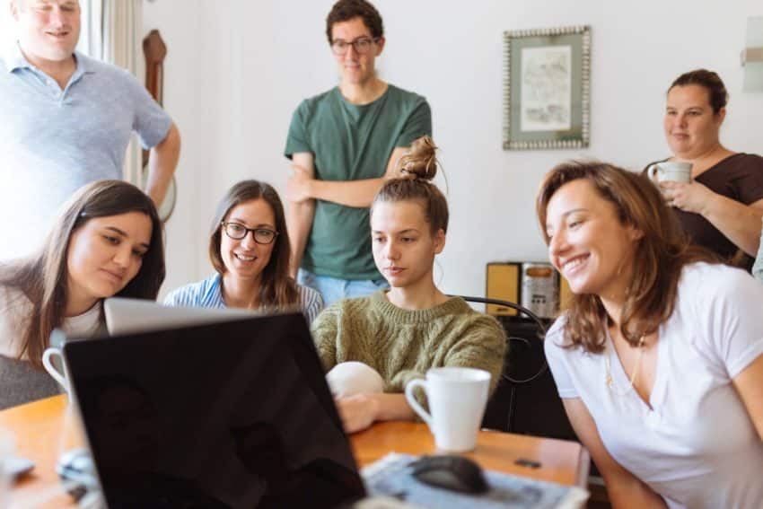 A female University of the People student leading a team.