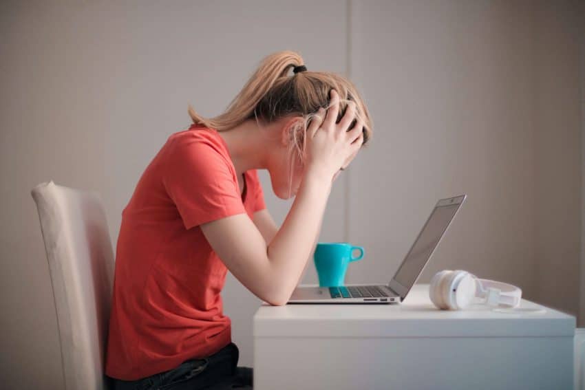 A student looking at her laptop at the University of the People