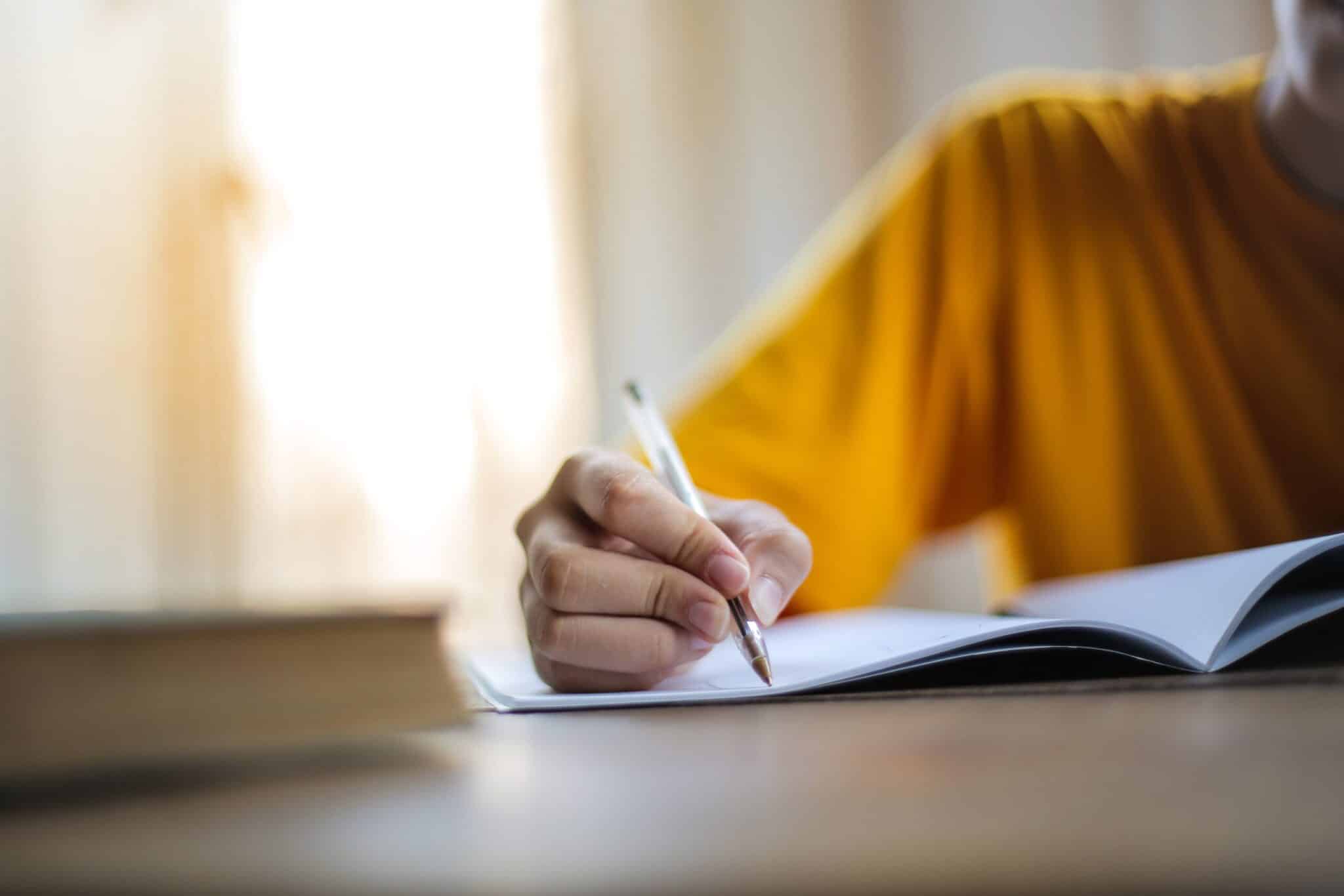 person with pen in hand