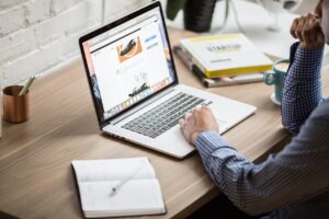 Man at laptop studying online marketing degree