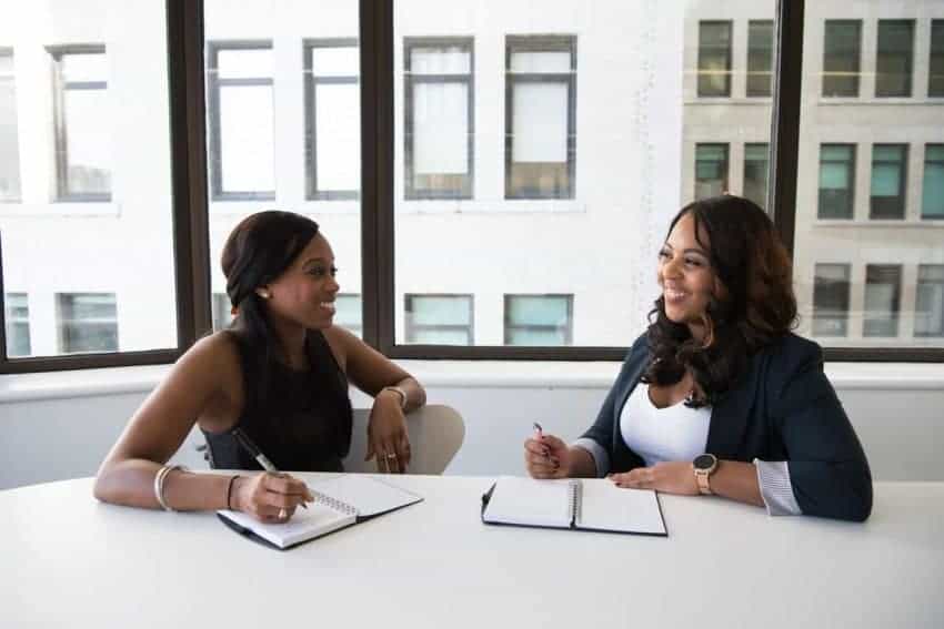 Two women in a meeting for tuition reimbursement