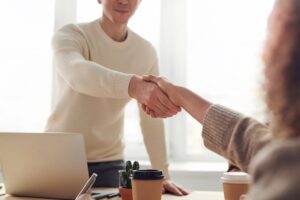 man and woman shaking hands during salary negotiations